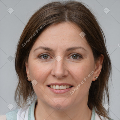 Joyful white adult female with medium  brown hair and brown eyes