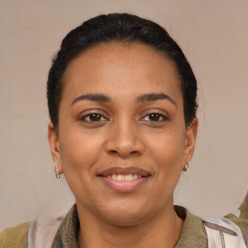 Joyful latino young-adult female with short  black hair and brown eyes