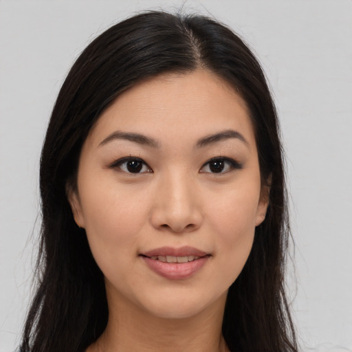 Joyful asian young-adult female with long  brown hair and brown eyes