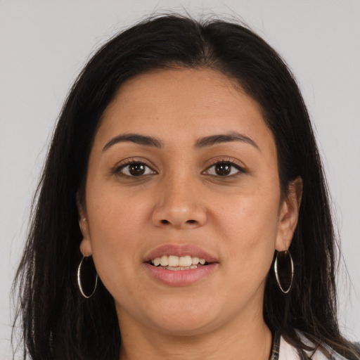 Joyful latino young-adult female with long  brown hair and brown eyes