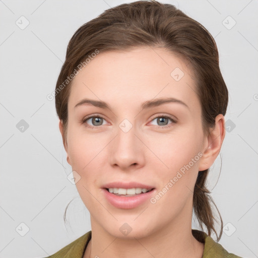 Joyful white young-adult female with medium  brown hair and grey eyes