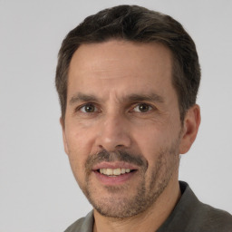 Joyful white adult male with short  brown hair and brown eyes