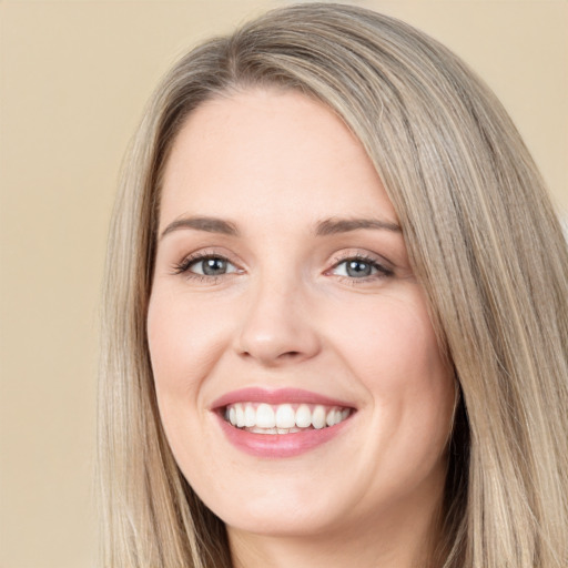 Joyful white young-adult female with long  brown hair and green eyes