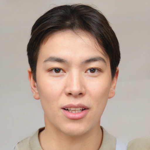 Joyful asian young-adult male with short  brown hair and brown eyes
