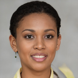 Joyful black young-adult female with short  brown hair and brown eyes