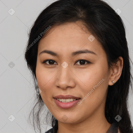 Joyful latino young-adult female with long  brown hair and brown eyes