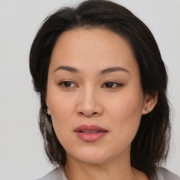 Joyful asian young-adult female with medium  brown hair and brown eyes