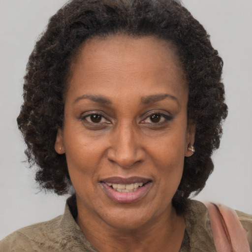 Joyful black adult female with short  brown hair and brown eyes