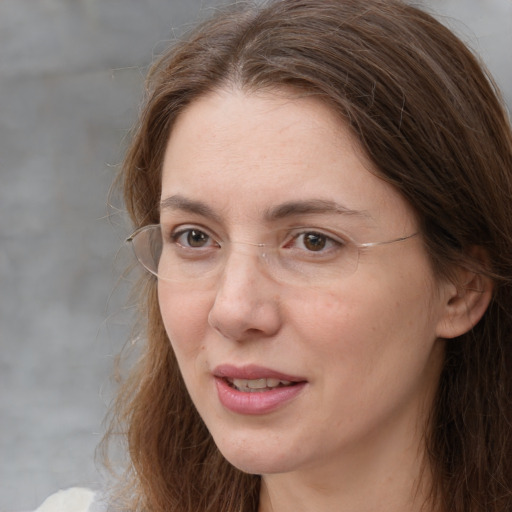 Joyful white adult female with long  brown hair and brown eyes