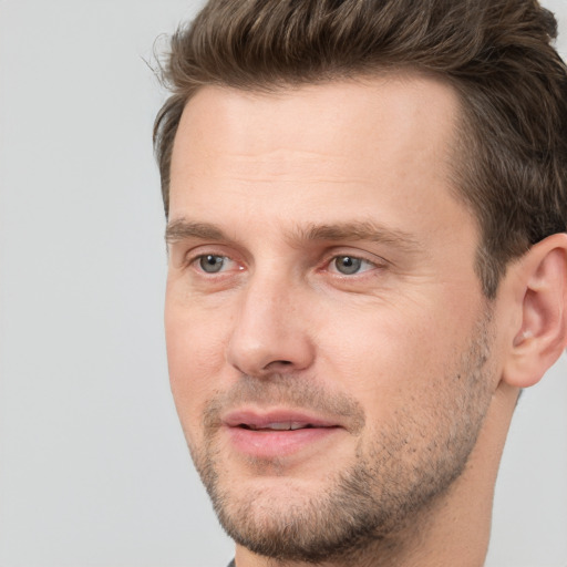 Joyful white adult male with short  brown hair and brown eyes