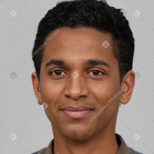 Joyful black young-adult male with short  black hair and brown eyes