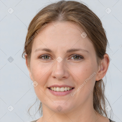 Joyful white young-adult female with medium  brown hair and grey eyes