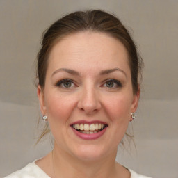 Joyful white young-adult female with medium  brown hair and grey eyes