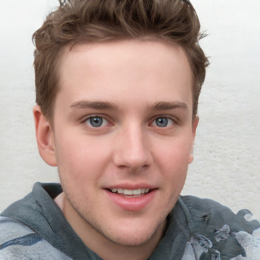 Joyful white young-adult male with short  brown hair and blue eyes