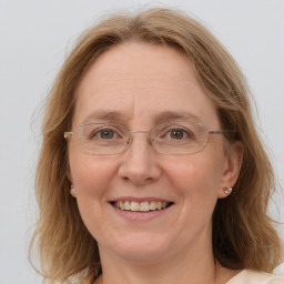 Joyful white adult female with medium  brown hair and blue eyes