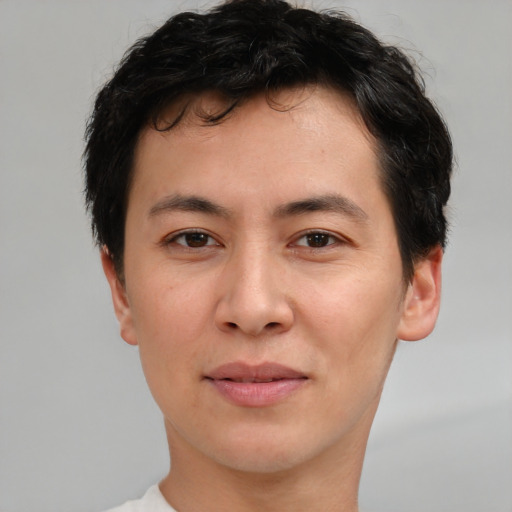 Joyful asian young-adult male with short  brown hair and brown eyes
