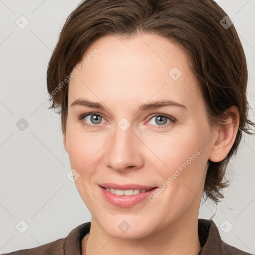 Joyful white adult female with medium  brown hair and grey eyes