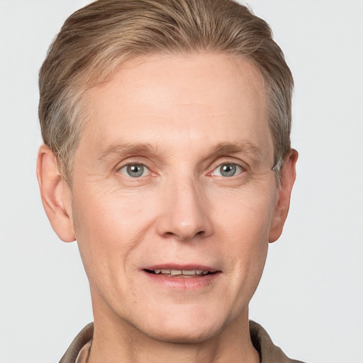 Joyful white adult male with short  brown hair and grey eyes