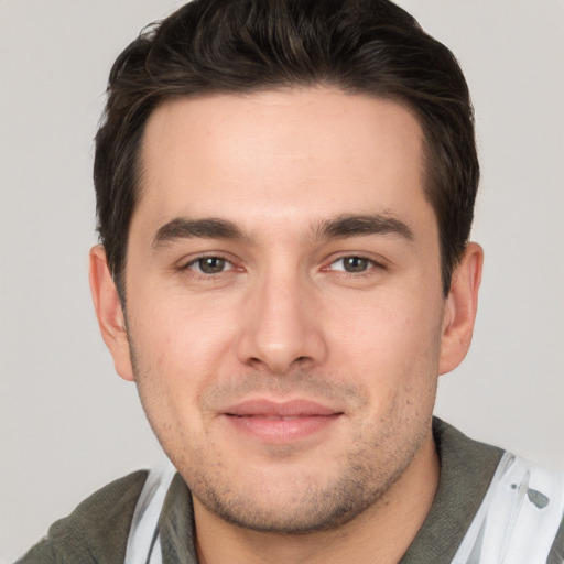 Joyful white young-adult male with short  brown hair and brown eyes