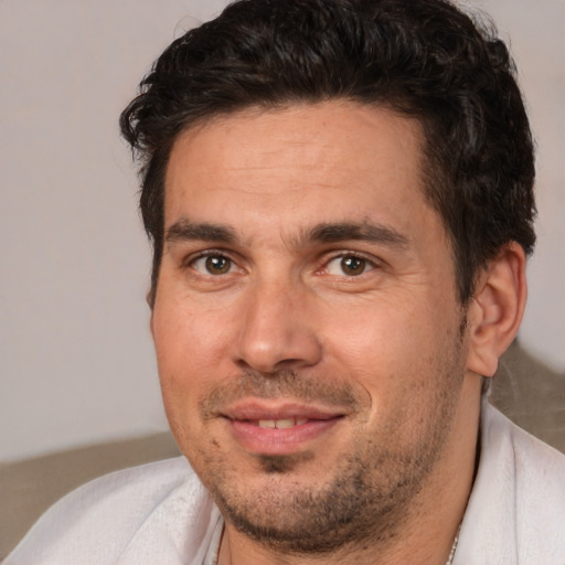 Joyful white adult male with short  brown hair and brown eyes