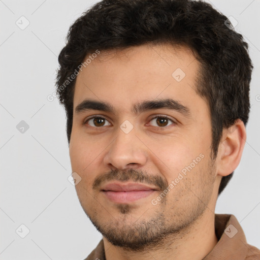 Joyful white young-adult male with short  black hair and brown eyes