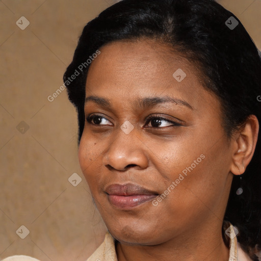 Joyful black young-adult female with short  black hair and brown eyes