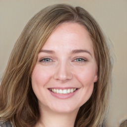 Joyful white young-adult female with long  brown hair and blue eyes