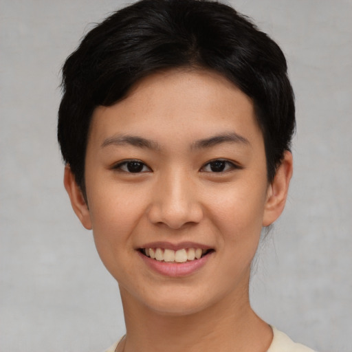 Joyful asian young-adult female with short  black hair and brown eyes