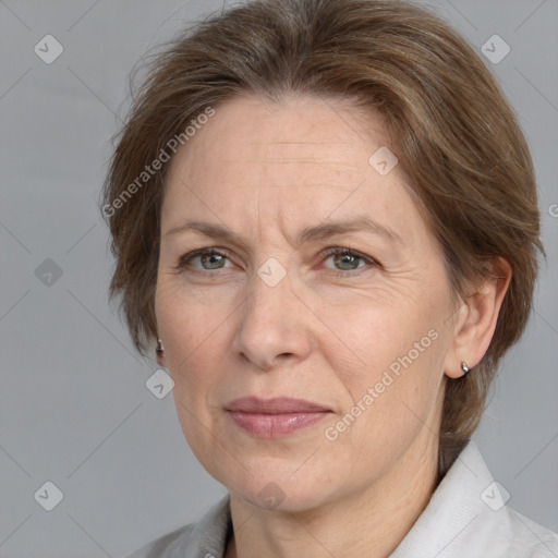 Joyful white adult female with medium  brown hair and grey eyes