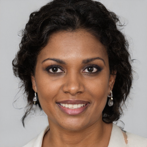 Joyful black young-adult female with medium  brown hair and brown eyes