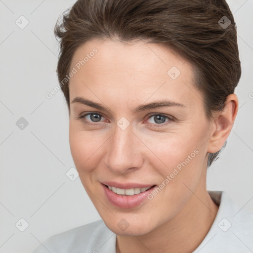 Joyful white young-adult female with short  brown hair and brown eyes