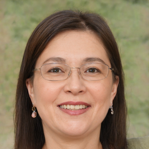 Joyful white adult female with long  brown hair and brown eyes