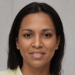 Joyful latino young-adult female with long  brown hair and brown eyes