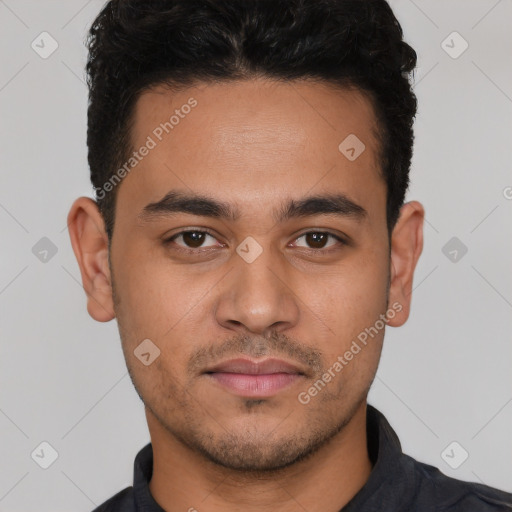 Joyful white young-adult male with short  black hair and brown eyes