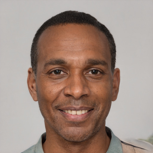Joyful black adult male with short  black hair and brown eyes