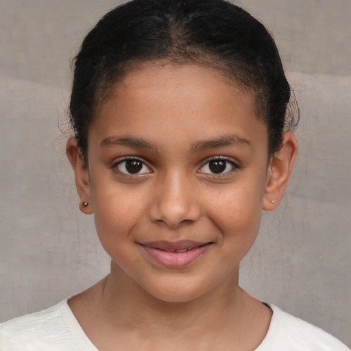 Joyful latino child female with short  brown hair and brown eyes