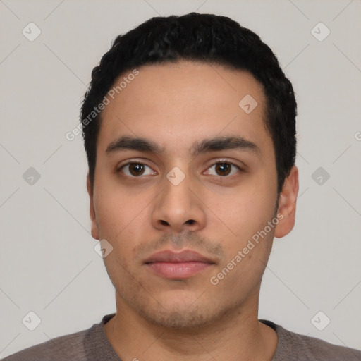 Neutral latino young-adult male with short  black hair and brown eyes