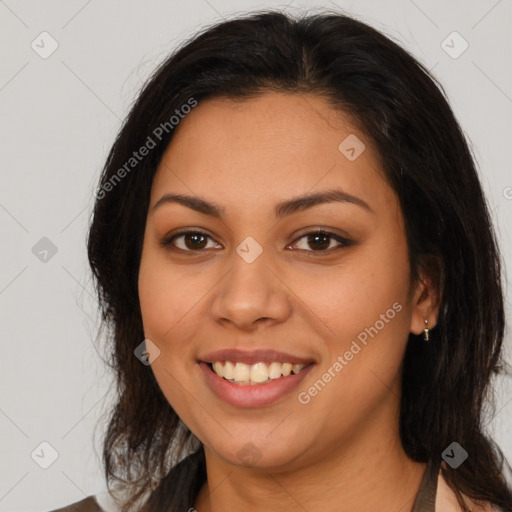 Joyful latino young-adult female with medium  brown hair and brown eyes
