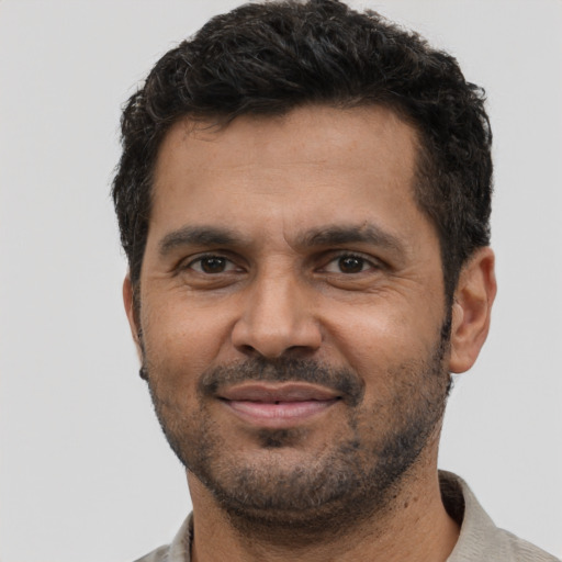 Joyful black young-adult male with short  brown hair and brown eyes