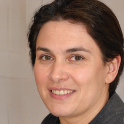 Joyful white adult female with medium  brown hair and brown eyes