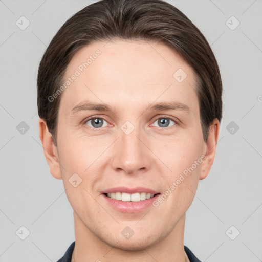 Joyful white young-adult male with short  brown hair and grey eyes