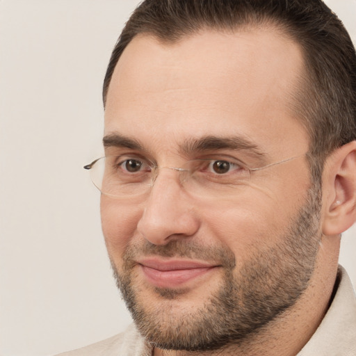 Joyful white adult male with short  brown hair and brown eyes