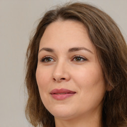 Joyful white adult female with long  brown hair and brown eyes