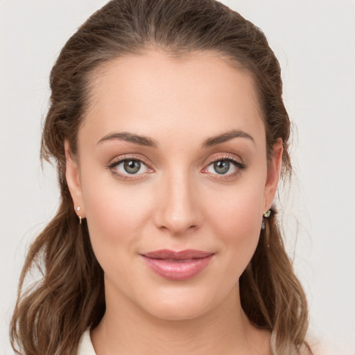 Joyful white young-adult female with medium  brown hair and grey eyes