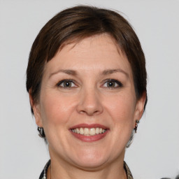 Joyful white adult female with medium  brown hair and grey eyes