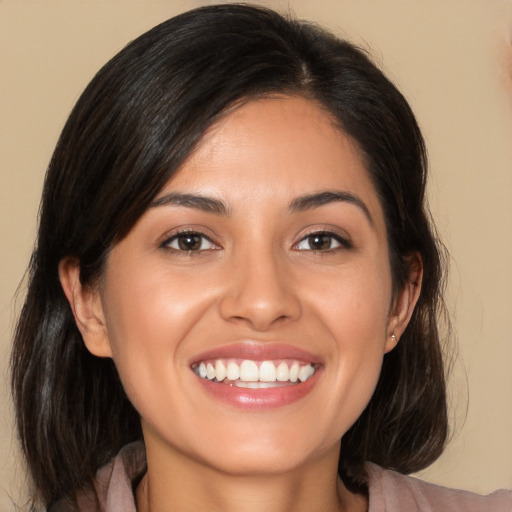 Joyful white young-adult female with medium  brown hair and brown eyes