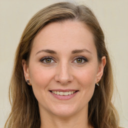 Joyful white young-adult female with long  brown hair and green eyes