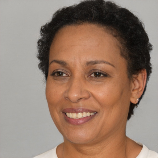 Joyful black adult female with short  brown hair and brown eyes