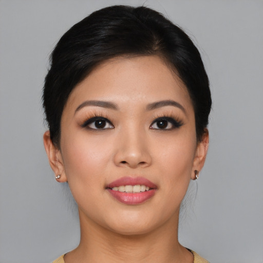 Joyful asian young-adult female with short  black hair and brown eyes