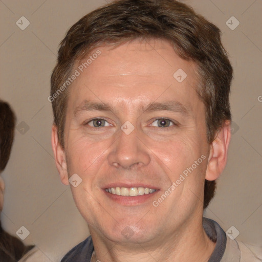 Joyful white adult male with short  brown hair and brown eyes